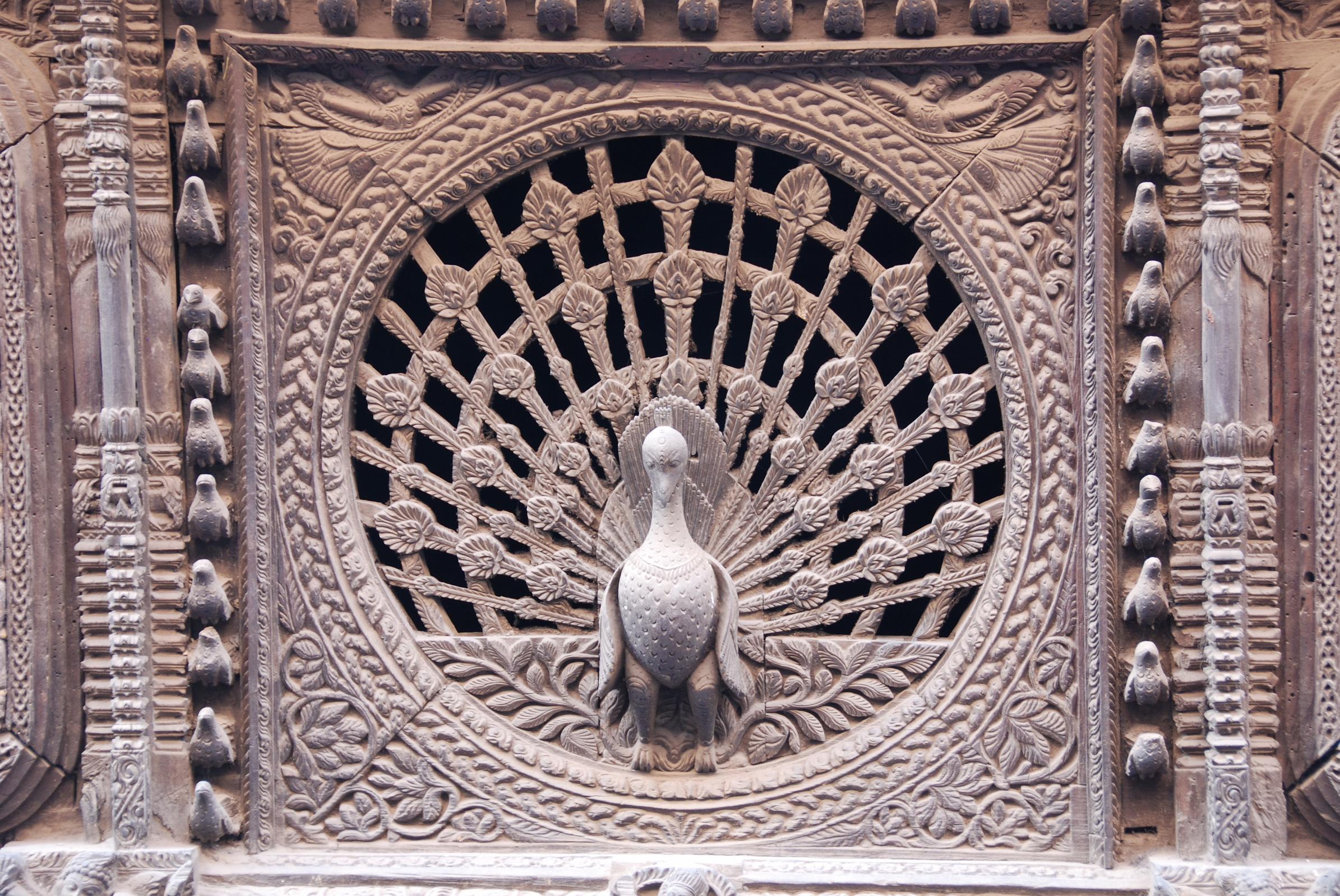 Kathmandu Bhaktapur 09 Peacock Window The 15C peacock window near Pujari Math in Bhaktapur is reputed to be the finest carved window in the Kathmandu Valley. I went to the upper floor window of the shop opposite to get a better photo.